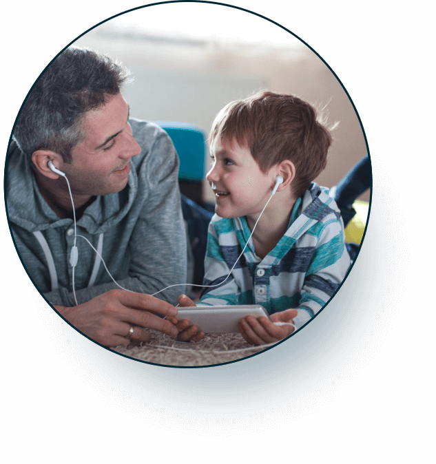 father and son making a hearing connection with headphones